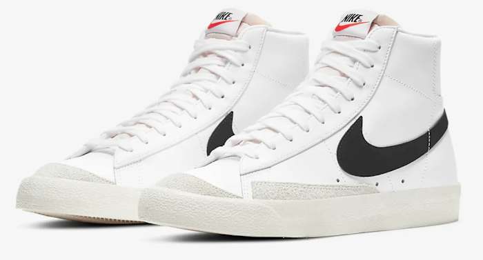 Side view of white and black Nike sneakers.